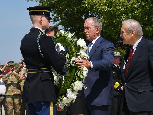 Former US President George W. Bush and former Defence Secretary Donald Rumsfeld take part in a wreath laying ceremony at the Pentagon Memorial. Picture: AP