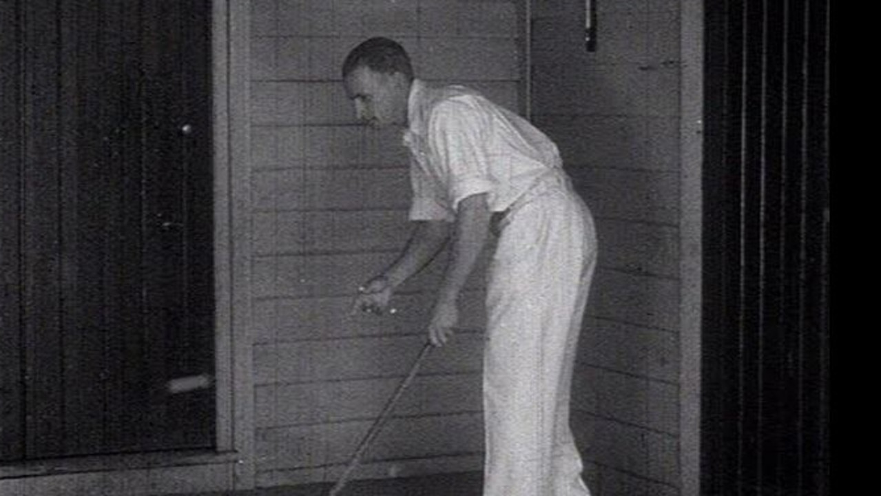 Bradman recreating his stick and golf ball routine.