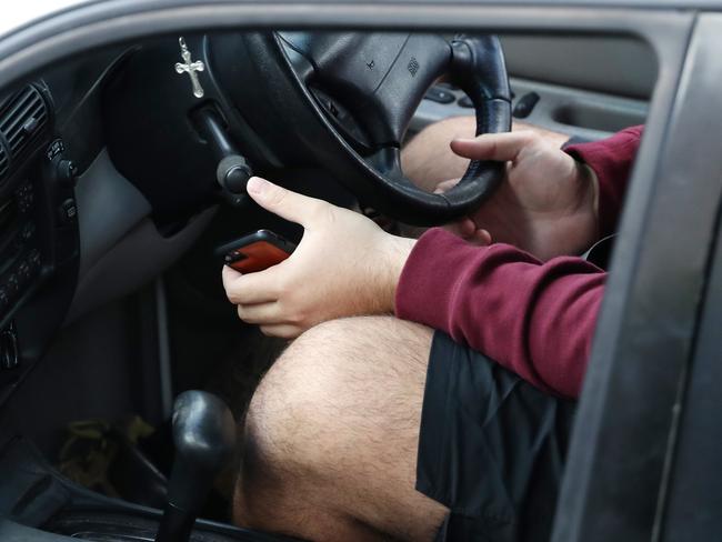 A man held the phone and his steering wheel at the same time. Picture: Liam Kidston