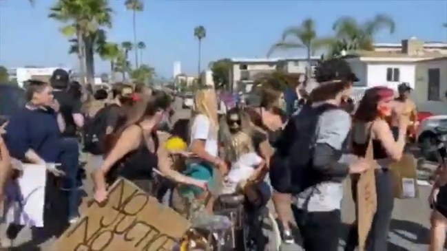 Newport Beach Protesters Scatter as Car Drives Through Group, Narrowly Missing Young Child