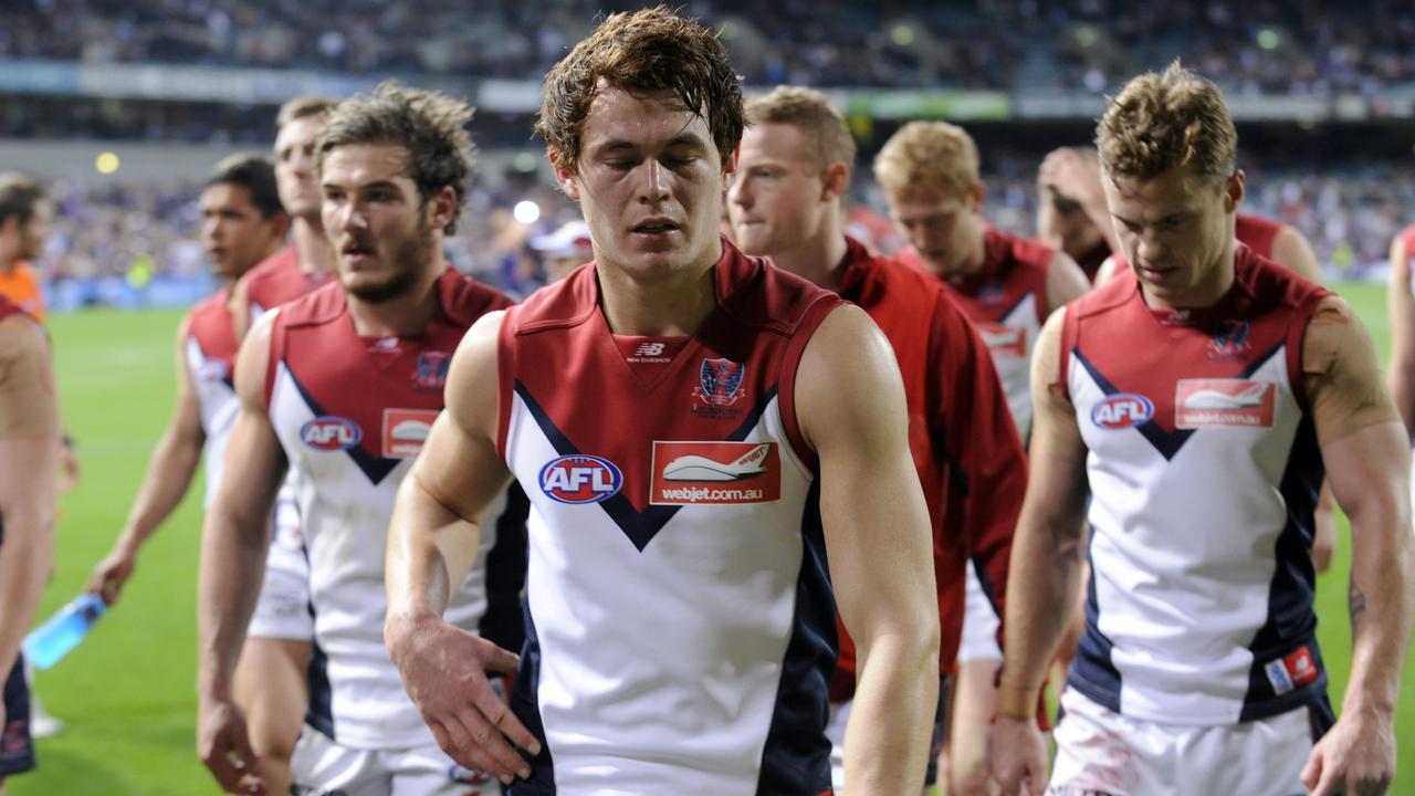 AFL-Fremantle Dockers v Melbourne Demons. pictured-Demons' players leave the field following their loss to Fremantle