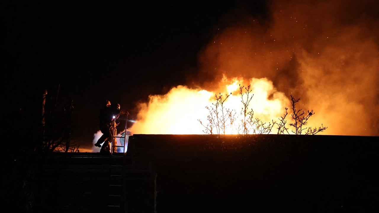 Ukrainian firefighters work to extinguish flames after an air-attack, in Dnipro. (AFP)