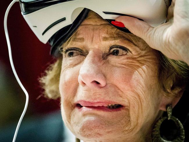 Dutch businesswoman, former politician and European commissioner, Neelie Kroes, reacts as she tries on a Virtual Reality (VR) headset during the StartupDelta at the Startup Fest Europe in Amsterdam on May 24, 2016. The Startup Fest Europe gathers international keynote-speakers to discuss the latest innovations, products and services. The event runs from May 24 to 28, 2016. / AFP PHOTO / ANP / Robin van Lonkhuijsen / Netherlands OUT