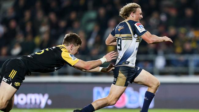 Brumbies’ Joe Powell beats the tackle of Hurricanes’ Jordie Barrett earlier this year.