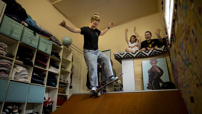 Olympic skateboarder Poppy Starr Olsen, watched by Millicent Ashley and her sister Kip, on her bedroom ramp. Picture: Peter Stoop