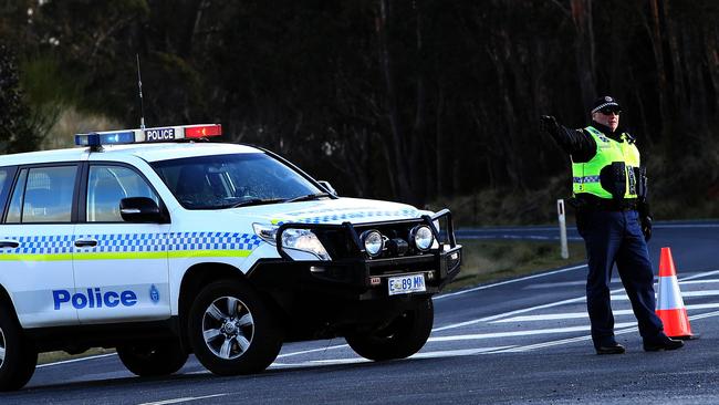 A Tasmania Police officer directs traffic away from a fatal accident on the Murchison Highway near Waratah earlier this week. Picture: CHRIS KIDD