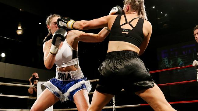 AFLW footballer Tayla Harris (white top) during a boxing match, which she won. Picture : Ian Currie