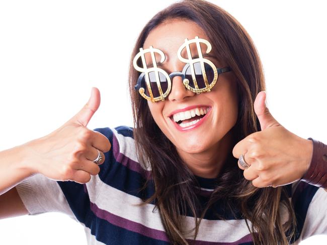 Laughing woman with Dollar sunglasses showing thumbs up with both hand, studio shot isolated on white; money celebration generic