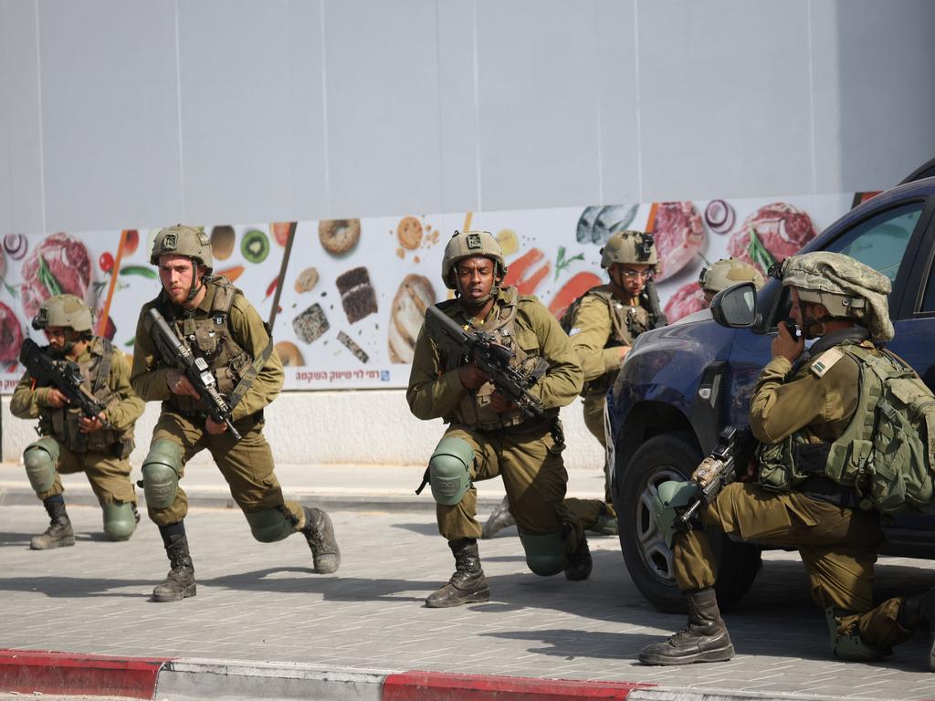 Israeli soldiers deploy in an area where civilians were killed in the southern city of Sderot. Picture: AFP