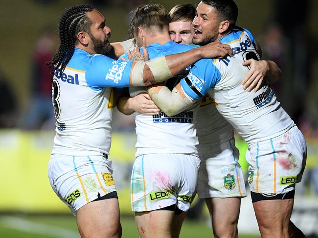 AJ Brimson of the Titans (second right) celebrates with team mates after scoring a try during the Round 23 NRL match between the Manly-Warringah Sea Eagles and the Gold Coast Titans at Lottoland in Sydney, Friday, August 17, 2018. (AAP Image/Dan Himbrechts) NO ARCHIVING, EDITORIAL USE ONLY