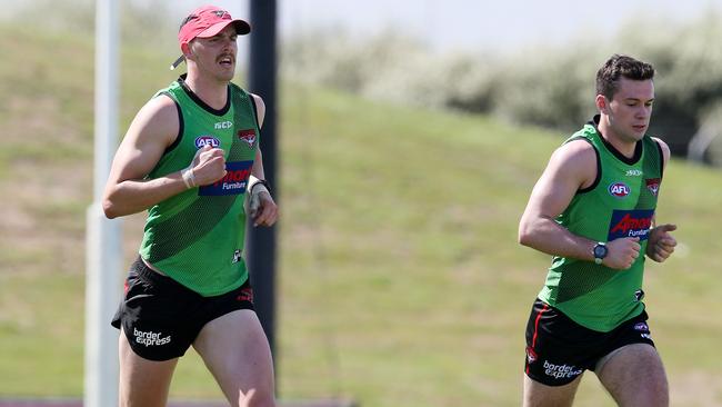 Joe Daniher and Conor McKenna run laps. Picture: Michael Klein