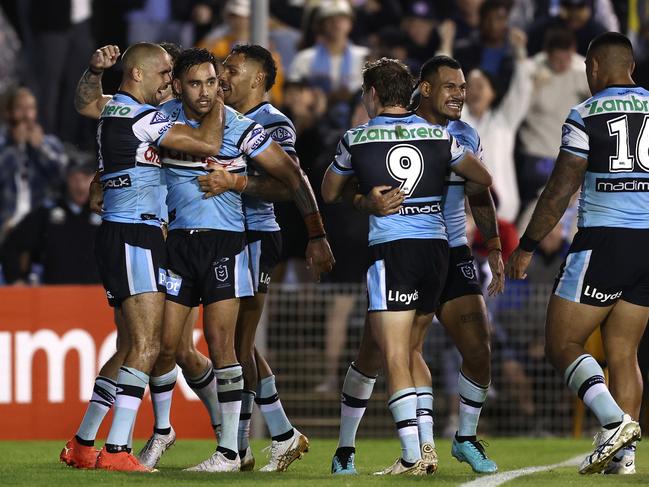 SYDNEY, AUSTRALIA - APRIL 14:  Briton Nikora of the Sharks celebrates with team mates after scoring a try during the round seven NRL match between the Cronulla Sharks and Sydney Roosters at PointsBet Stadium on April 14, 2023 in Sydney, Australia. (Photo by Matt King/Getty Images)