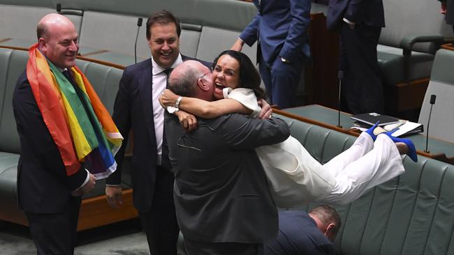 Liberal MP Warren Entsch lifts up Labor MP Linda Burney as they celebrate the passing of the Marriage Amendment Bill in the House of Representatives on December 7, 2017. Picture: AAP Image/Lukas Coch