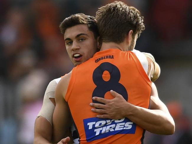 Tim Taranto of the Giants (left) celebrates with team mate Callan Ward of the Giants after scoring a goal during the Round 4 AFL match between the Greater Western Sydney (GWS) Giants and the Fremantle Dockers at UNSW Canberra Oval in Canberra, Saturday, April 14, 2018. (AAP Image/Lukas Coch) NO ARCHIVING, EDITORIAL USE ONLY