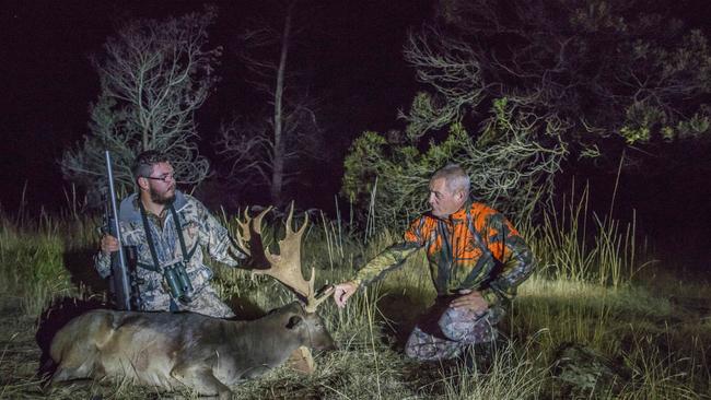 Tasmanian Deer hunters Jonathan McGee and Andrew Winwood with a stag (Fallow Deer) that Jonathan shot at dusk on a Midlands property in Northern Tasmania. Picture: Supplied.