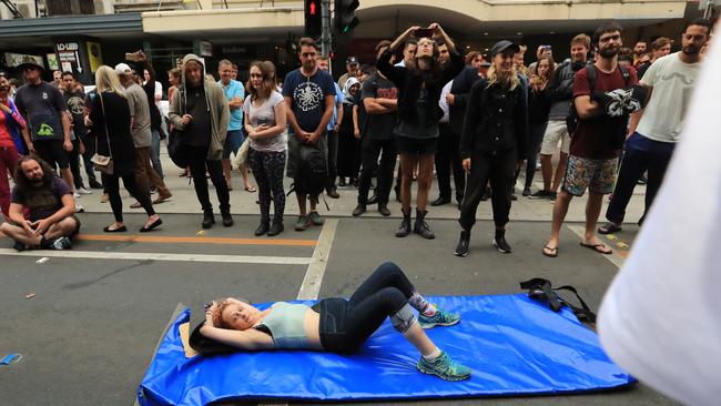 A woman lies down on Flinders St. Picture: Alex Coppel.