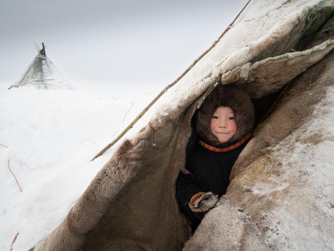 The Nenets - an indegenous people in Arctic Russia - spend their winter months inside their traditional tent, the Chum. To preserve heat, the opening of the tent is kept as small as possible, but children can’t resist a sneaky peak outside. Picture: Chiara Felmini