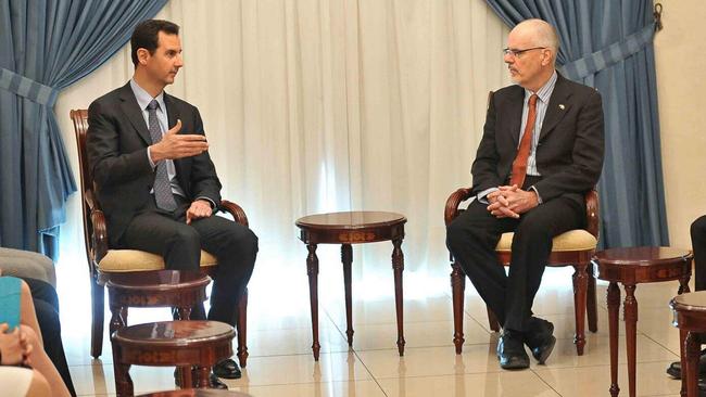 Syrian President Bashar al-Assad (left) meets with Australian academic Tim Anderson in Damascus in 2013.