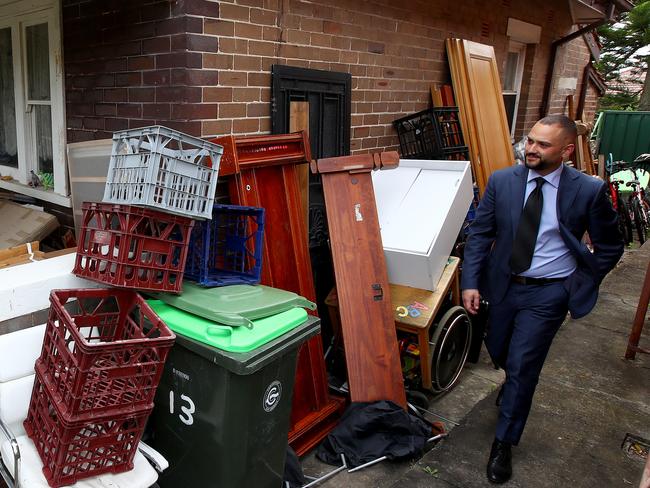 WEEKEND TELEGRAPHS SPECIAL. MUST TALK WITH PIC ED JEFF DARMANIN BEFORE PUBLISHING -A hoarder house in Earlwood is set to go auction next month without a reserve. Agent Dean Vasil from Ray White Real Estate looks through the property before it goes under the hammer. Picture: Toby Zerna