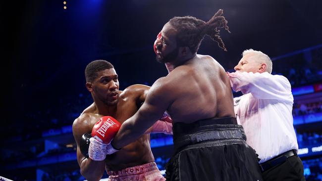 Anthony Joshua punches Jermaine Franklin after the final bell as the referee attempts to break them up. (Photo by James Chance/Getty Images)