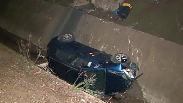 A man was forced to climb through a window to escape a wreckage after his car plunged five metres down a drain and landed on its side at Kurralta Park. Picture: 9News Adelaide/Georgia Westgarth