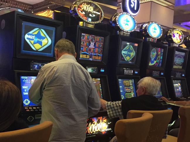 Generic image taken from a phone, unidentified people playing Poker machines, pokies, at The Star Casino in Pyrmont. The machines have been freezing, locking up preventing people from playing at times today. Pic Chris Pavlich.