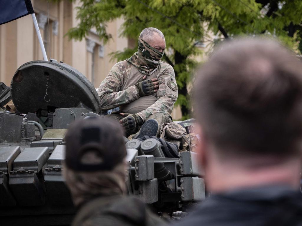 A member of Wagner Group sits atop of a tank in a street in the city of Rostov-on-Don, on Saturday. Picture: AFP