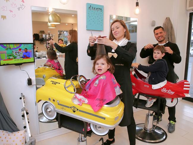 Carlo &amp; Elise hairdresser Ando Szalai and owner Marco Quivaqui with Isla Pope, 2, and Hugo, 5. Picture: Adam Ward