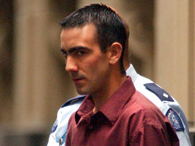 Jason Roberts is taken to a waiting prison van from Melbourne Supreme Court in 2002.