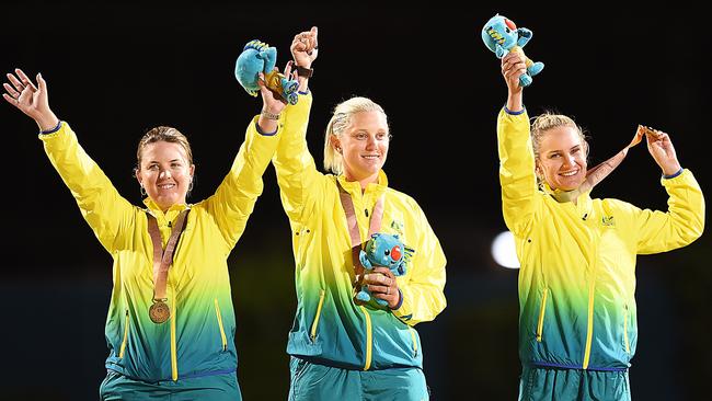 The victorious women’s triples lawn bowls team of Rebecca van Asch, left, Natasha Scott and Carla Krizanic pose with their gold medals. Picture: Albert Perez/Getty