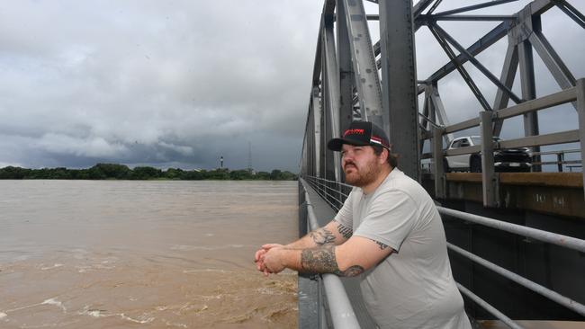 Wednesday February 5. Heavy rain causes flooding in North Queensland. Dalton McInerney on the Burdekin Bridge at Ayr looks at the vast amount of water flowing down the river. Picture: Evan Morgan