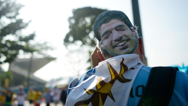 A fan wearing a Luis Suarez mask.