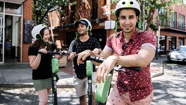 Natasha Taylor of Hallett Cove, Akram and Ayman Kasim of Woodville riding the Lime Scooters for the first time in Adelaide in February, 2019. Picture: AAP Image/Morgan Sette