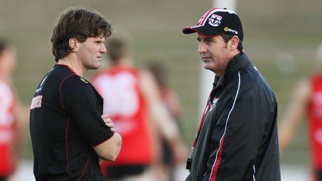 Ross Lyon and Robert Harvey speak at a St Kilda training session.