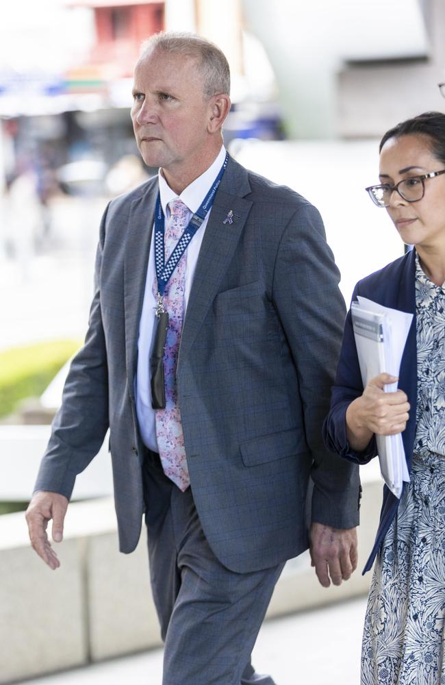 Queensland Police Union boss Ian Leavers, flanked by his lawyers, arrives at the police domestic violence inquiry on Friday. Picture: Matthew Poon