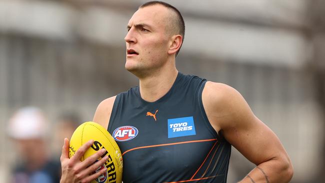 MELBOURNE, AUSTRALIA - AUGUST 18: Braydon Preuss of the Giants runs with the ball during a GWS Giants AFL training session at Punt Road Oval on August 18, 2021 in Melbourne, Australia. (Photo by Robert Cianflone/Getty Images)