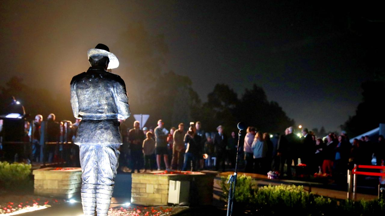 Observers congreate at the war memorial for the Pinegrove Anzac Day dawn service. Picture: Angelo Velardo