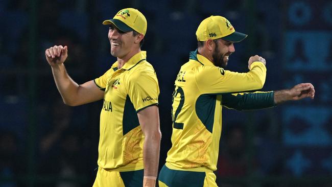 Australia's captain Pat Cummins and his teammate Glenn Maxwell celebrate after the dismissal of Netherlands' Vikramjit Singh. Photo by Arun SANKAR / AFP.