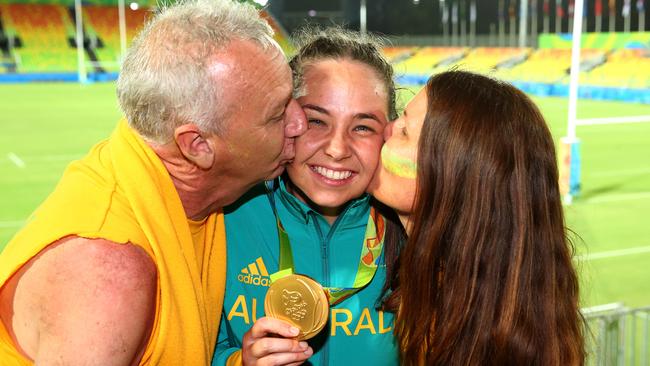 Chloe Dalton’s dad Brad and mum Penny seal her gold medal with a kiss in Rio. Picture: Adam Head