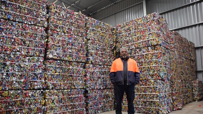 Cherbourg recycling plant manager, Andrew Beckett with cans ready for shipment.