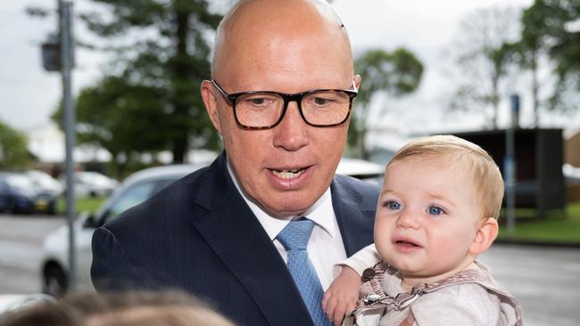 Peter Dutton holds the baby boy of Liberal candidate for the seat of Shortland Emma King as they meet local mothers at a cafe. Picture: Dan Peled/Getty Images
