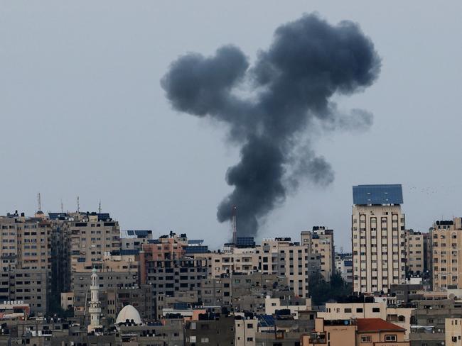 A plume of black smoke rises above Gaza after retaliation attacks. Picture: Mahmud Hams AFP