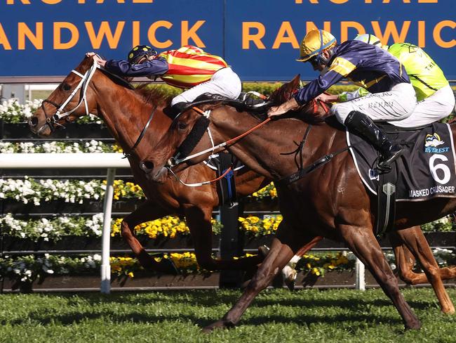 Nature Strip (L), ridden by jockey James McDonald, takes a lead to win the Everest 2021 horse race at the Royal Randwick race course in Sydney on October 16, 2021. (Photo by David Gray / AFP) / XGTY-- IMAGE RESTRICTED TO EDITORIAL USE - STRICTLY NO COMMERCIAL USE --