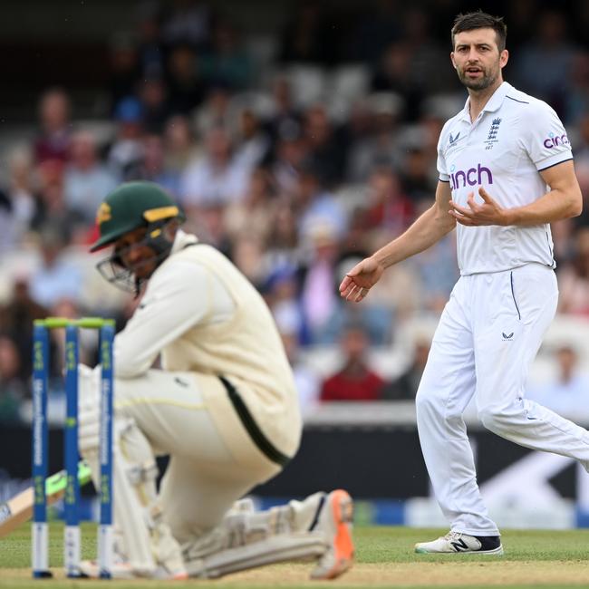 Usman Khawaja drops to the ground after being hit on the head by Mark Wood. (Photo by Stu Forster/Getty Images)