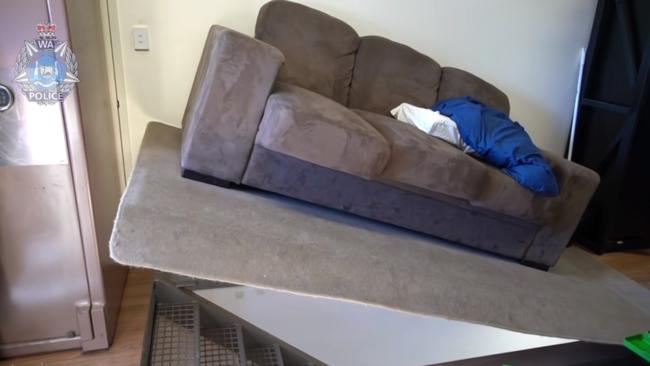 A hydraulic arm lifted the couch to uncover a secret underground bunker. Picture: WA Police/Seven