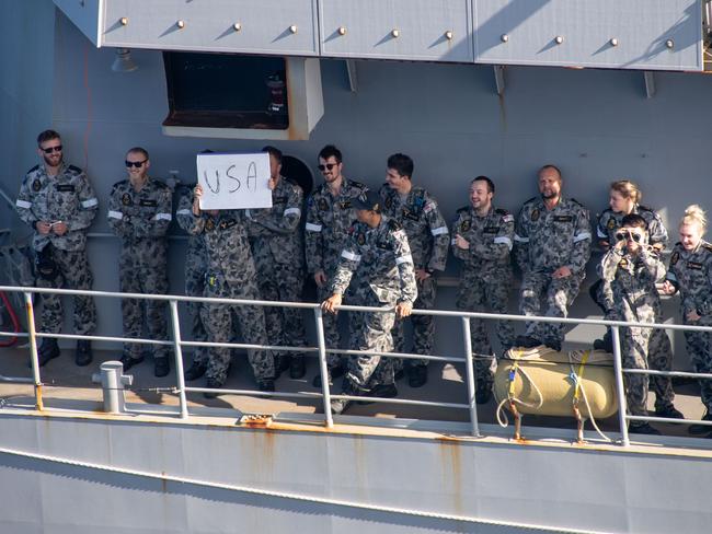 **DO NOT USE: ONLY FOR COURIER MAIL USE, THANK YOU** CORAL SEA (July 27, 2021) Sailors aboard the Royal Australian Navy frigate HMAS Ballarat (FFH 155) send friendly messages to Sailors aboard the forward-deployed amphibious assault ship USS America (LHA 6) during a fueling-at-sea between the two ships as part of Exercise Talisman Sabre 21. Australian and U.S. Forces combine biannually for Talisman Sabre, a month-long multi-domain exercise that strengthens allied and partner capabilities to respond to the full range of Indo-Pacific security concerns. (U.S. Navy photo by Mass Communication Specialist 2nd Class Shelby M. Tucker)**ONLY FOR COURIER MAIL USE**