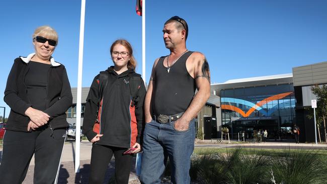 Year 7 student Taleea and parents, Adrian Clappis and Jeanita Burgess outside the school. Picture: Dean Martin