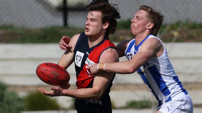 VFL: Coburg’s Aaron Clarke gets a handball away under pressure. Picture: Hamish Blair