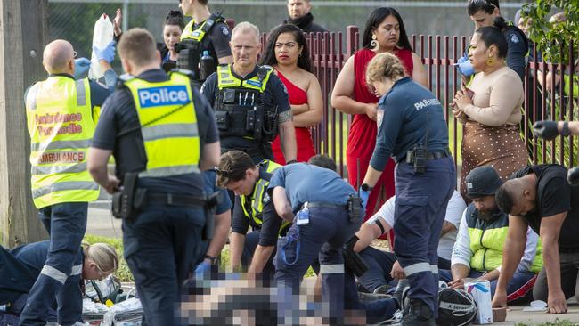 Shocked onlookers at the scene of an axe killing close to a Kealba primary school. Picture: Jay Town