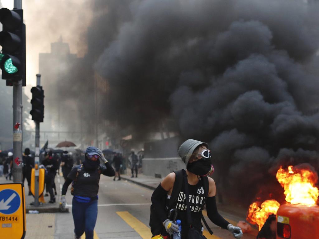 Protesters take cover in Hong Kong. Picture: AP